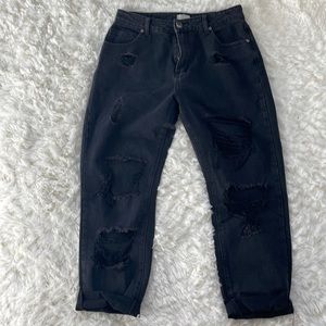 Distressed grunge style black faded jeans